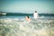 Couple floating in white clothes in water on beach