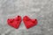 couple folding red paper hearts on cement wall for valentine pat