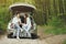 Couple in a forest sitting in a trunk