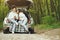 Couple in a forest sitting in a trunk