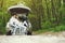 Couple in a forest sitting in a trunk