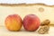 Couple of fresh peaches and kernels on a natural wooden board