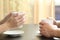 Couple or friends hands holding coffee cups