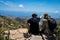 Couple of friends high on the mountain pointing the horizon