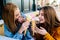 A couple of friends share their strawberry and vanilla ice creams outdoors