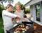 Couple in garden making barbecue