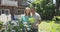 couple gardening in their backyard smiling at camera and holding basil plant