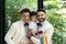 Couple gay carrying adopted child together in wedding day