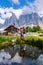 Couple at Geisler Alm, Dolomites Italy, hiking in the mountains of Val Di Funes in Italian Dolomites