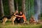 Couple with german shepherd dog near bonfire, nature background.