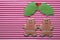 Couple gingerbread man with omela leaves on stripe background. Christmas gingerbread man cookies top view, text space