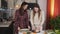 A couple of girls in the kitchen preparing the chicken baked in the oven and having fun talking to.