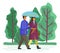 Couple goes in rain. Happy man and woman are walking in city park under an umbrella together