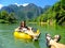 Couple going down Nam Song River in a tube surrounded by karst s