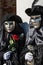 Couple with golden venetian mask and black costume with red and silver roses during venice carnival