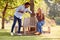 Couple Greeting By Touching Elbows On Socially Distanced Meeting In Outdoors During Health Pandemic