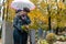 Couple in grief on a cemetery in fall