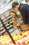 Couple at grocery store buying fruits