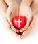 Couple hands holding heart with cross symbol