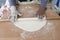 Couple of hands preparing dough on table