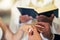 Couple hands with ring, wedding and marriage in church with priest and bible in traditional ceremony. Commitment, love