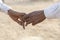 Couple hands on the street during Pushkar Camel Mela. Pushkar, Rajasthan, India, close up. In India, it is normal to go to men