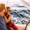 Couple in happiness enjoy a sail tour in yacht - love and romantic lifestyle relationship with adult people in summer holiday