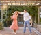 Couple, happy dancing together and outdoor love to celebrate relationship, cute dance spin and relationship activity