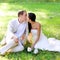 Couple happy in love kissing sitting in park