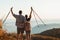 Couple happy to climb top of mountain and hold trekking sticks. Nordic walking