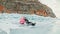 Couple has fun during winter walk against background of ice of f