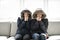 Couple have cold on the sofa at home with winter coat