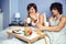 Couple having breakfast in bed served over tray