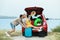 Couple having fun near car trunk with suitcases
