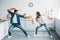 couple having fun and pretending fight with cleaning tools