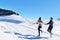 Couple having fun running down slope