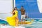 Couple having fun on tropical beach on the sailboat. Summer vacation concept.