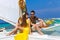 Couple having fun on tropical beach on the sailboat. Summer vacation concept.