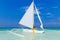 Couple having fun on tropical beach on the sailboat. Summer vacation concept.