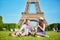 Couple having picnic near the Eiffel tower in Paris, France