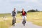 Couple having sea coast bicycle tour at levee