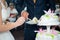 The couple held hands to cut the first piece, beautiful, wedding cake for their beloved parents