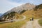 Couple of hikers on the alpine road near the village of Stuben am Arlberg. State of Vorarlberg, Austria, Europe