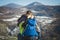 Couple of hikers with backpacks looking over mountains view