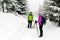 Couple hikers hiking in winter woods