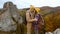 couple hikers hipsters stands on autumn landscape background with cliffs in national park Tustan, Ukraine. loving tender