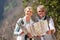 Couple hikers holding map