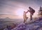 Couple of hikers look down into fogy valley. Photographer stay