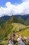 Couple of hikers resting at Machu Picchu overlook in Peru