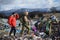 Couple of hikers walking across landfill, large pile of waste, environmental concept and eco activism.